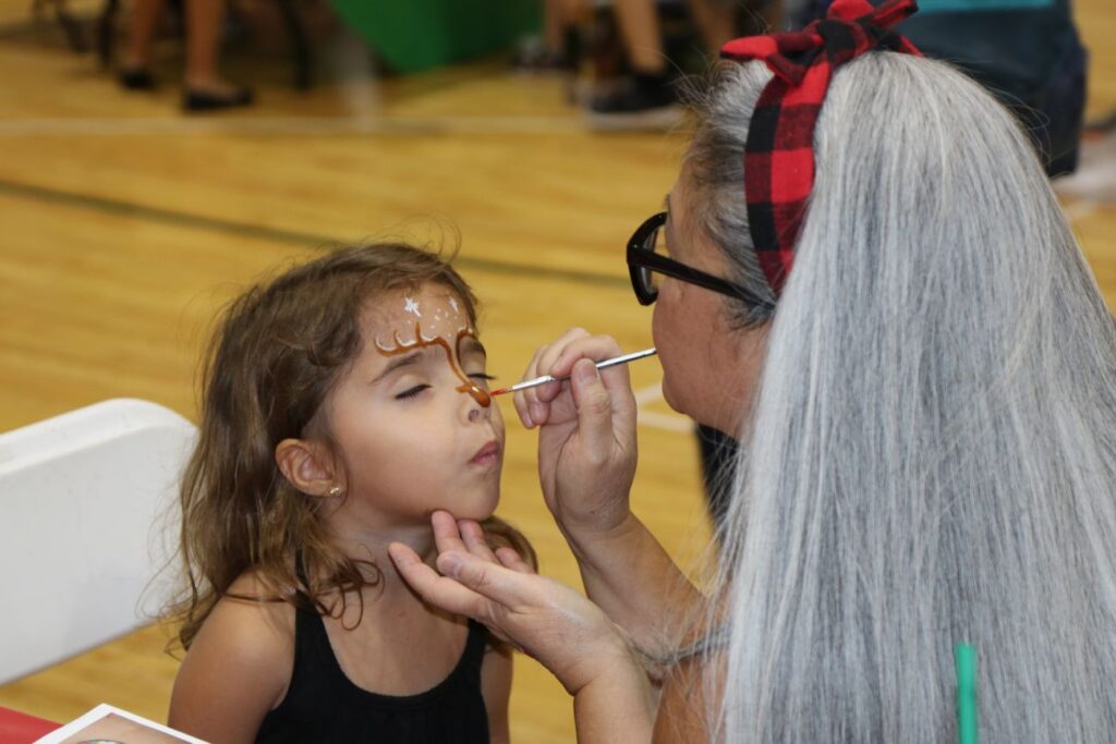 little girl getting face painted