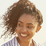 Smiling female associate testimonial portrait outdoors